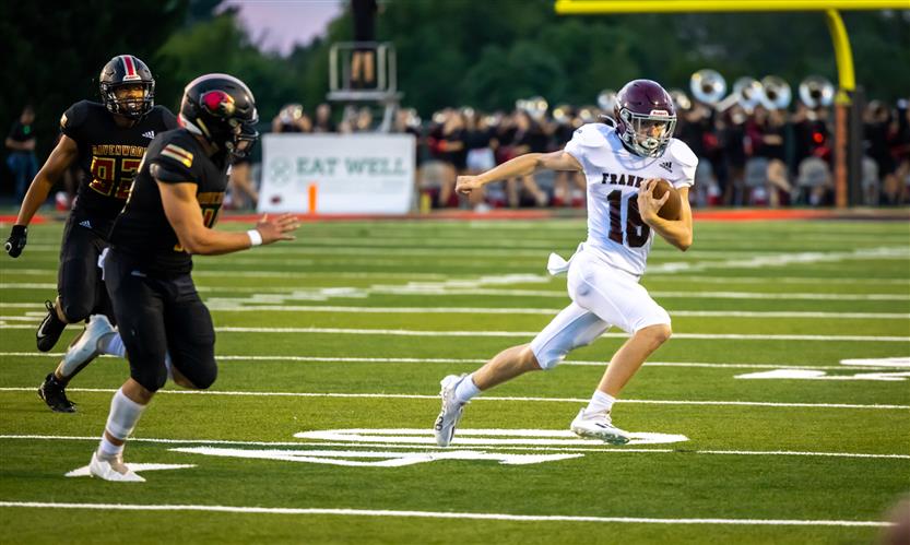 A football player runs the ball